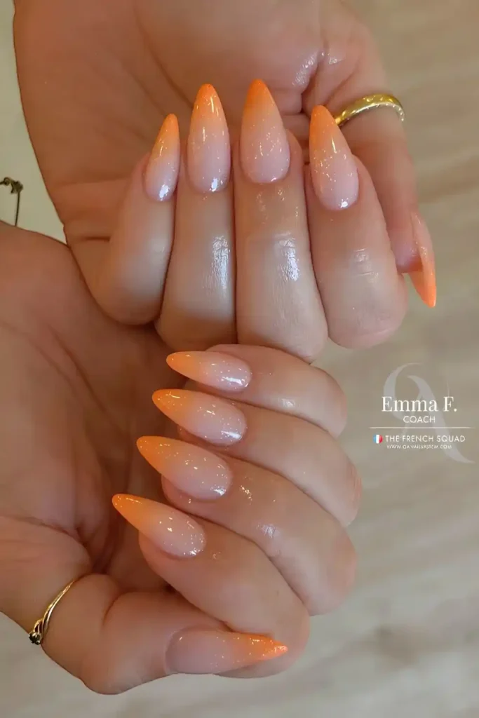 Milky White Base With Orange Ombre Nails And Subtle Shimmer