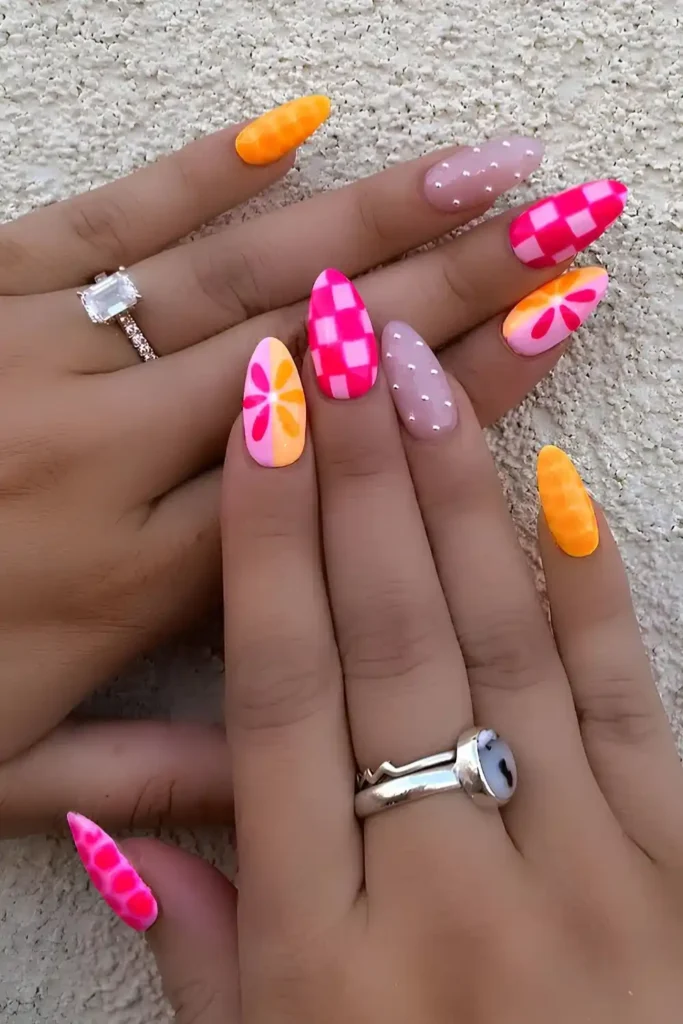 Pink And Orange Nails With Flowers And Checkerboard Art
