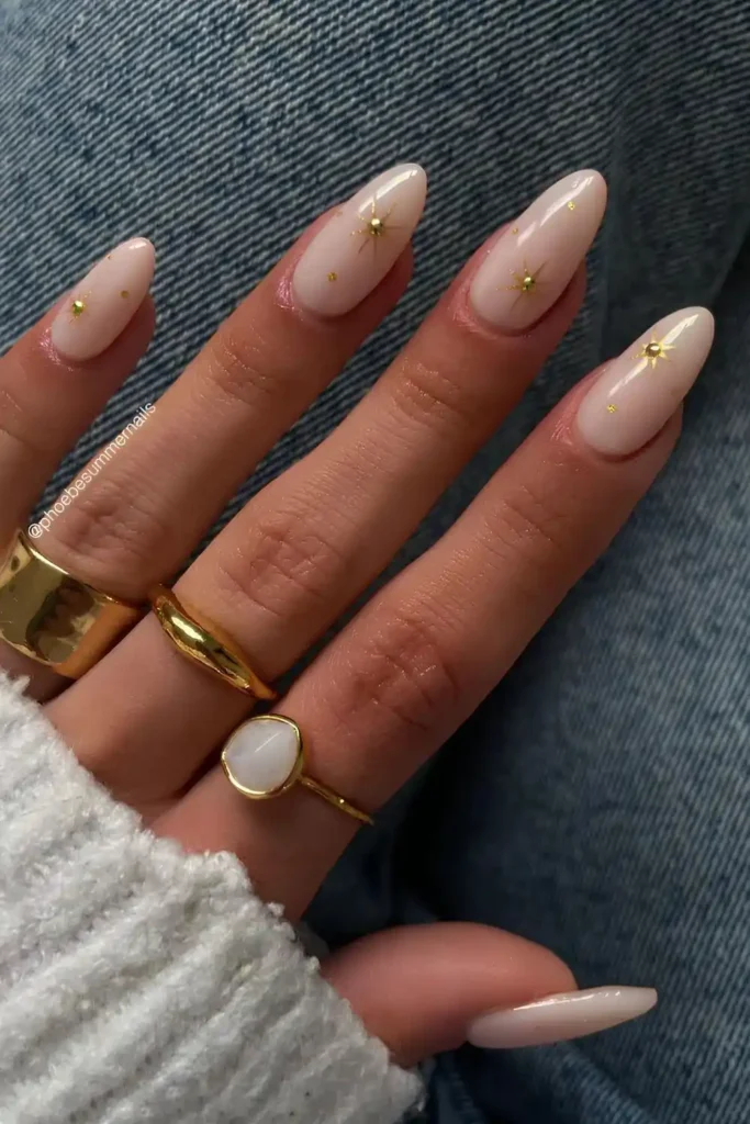 Milky White Nails With Gold Celestial Accents for a Dreamy Luxe Look