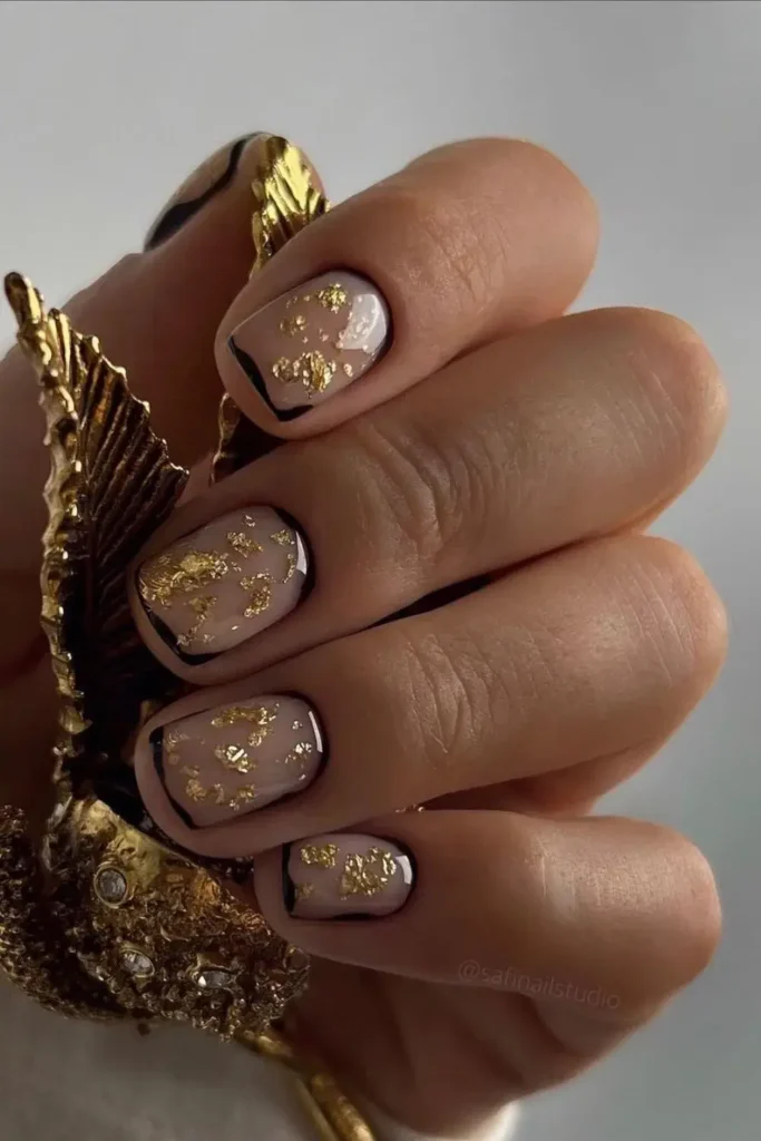 Abstract Nails With Black and Gold Accents That Make a Bold Statement