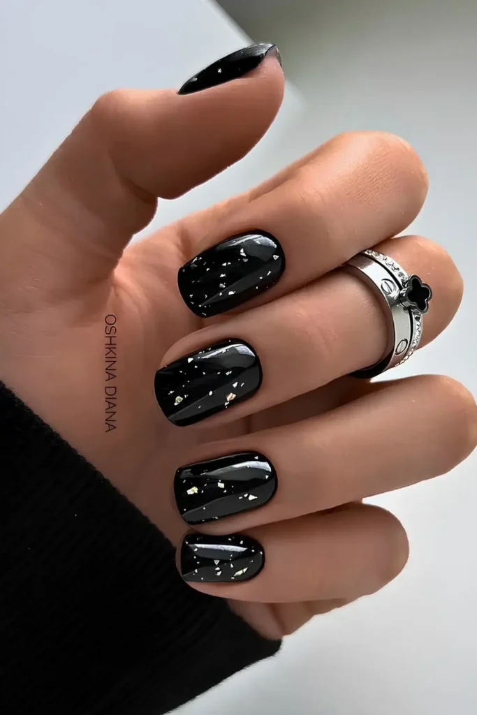 Black Nails With Accent Silver Foil Flakes for a Luxe Look