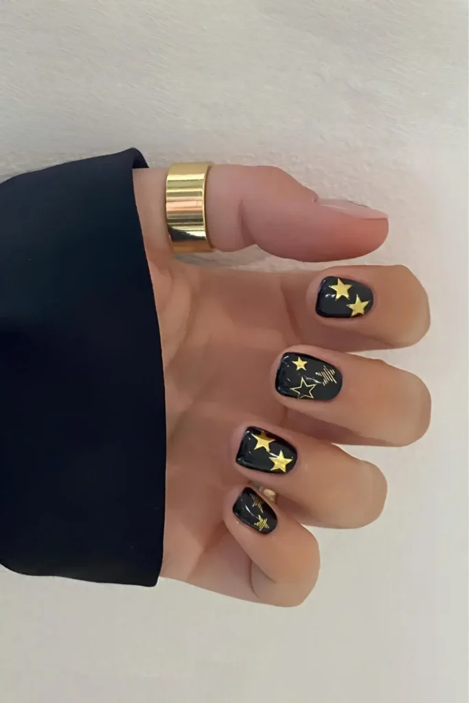 Black Nails With Gold Star Art That Stands Out