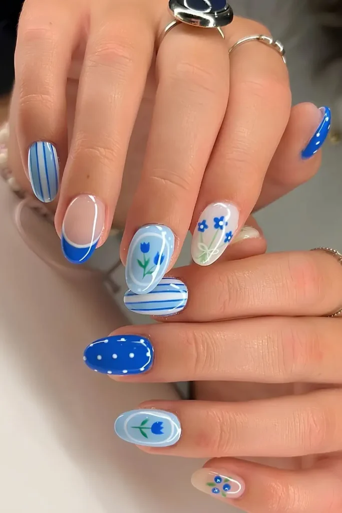 Blue Mix and Match Nails With Florals and Blueberries That Feel Playful