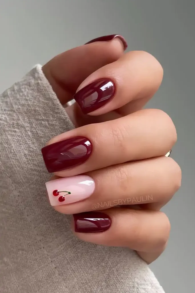 Burgundy Manicure With Accent Cherry Art for a Playful Finish