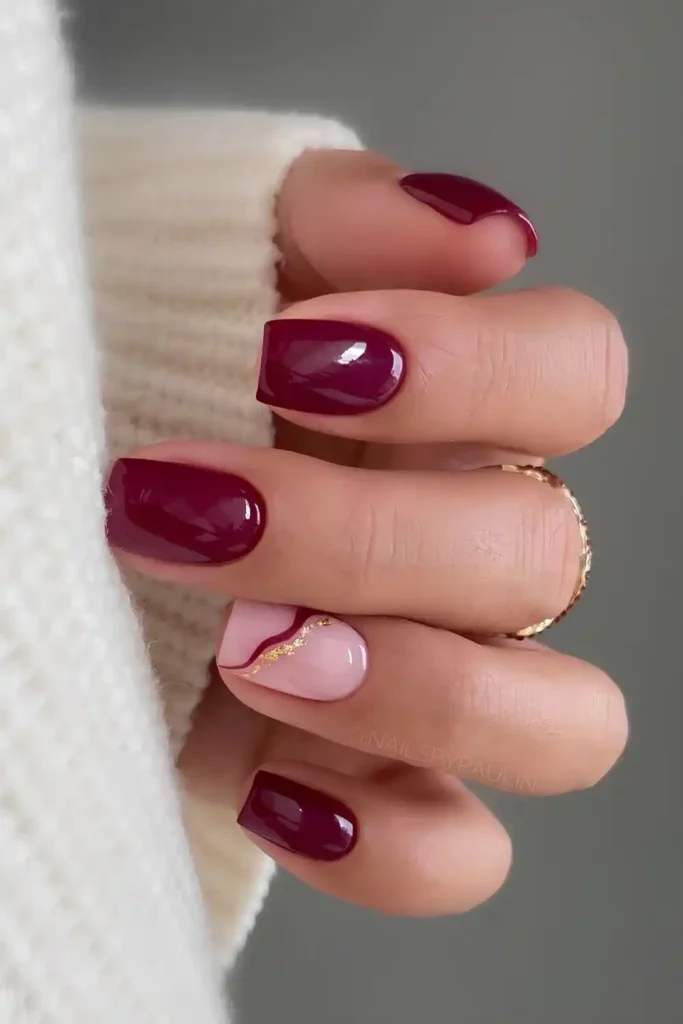 Burgundy Nails With Accent Gold Lines That Elevate the Look