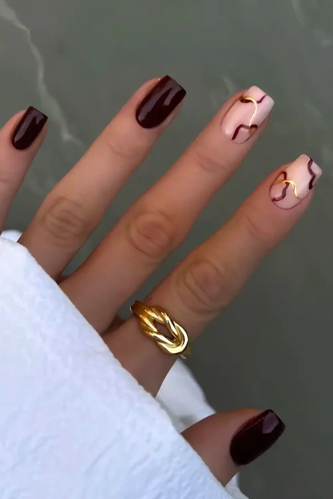 Burgundy Nails With Gold Line Art for a Sophisticated Style