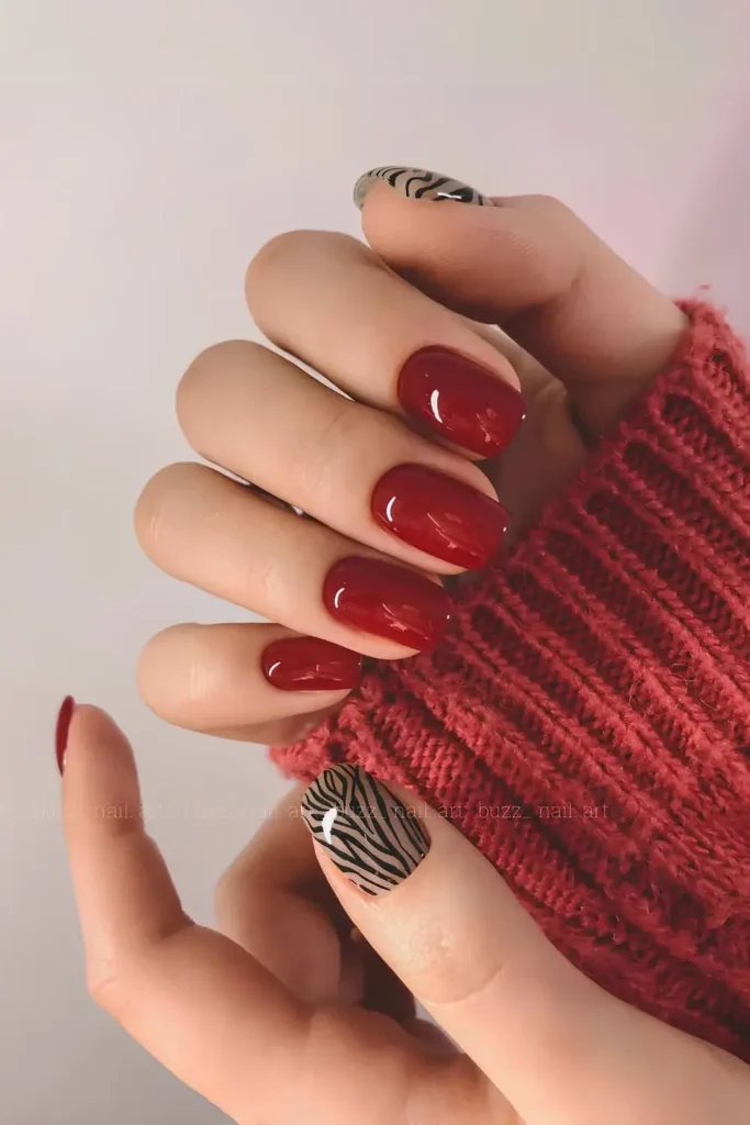 Cherry Red Nails With Zebra Print Accent That Make a Bold Statement