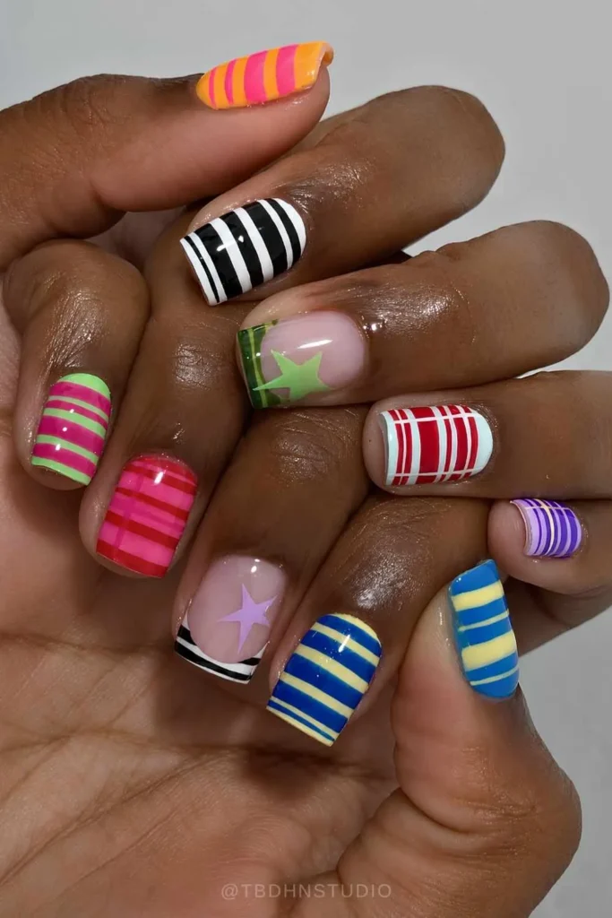Colorful Short Striped Nails With Star Accents That Stand Out