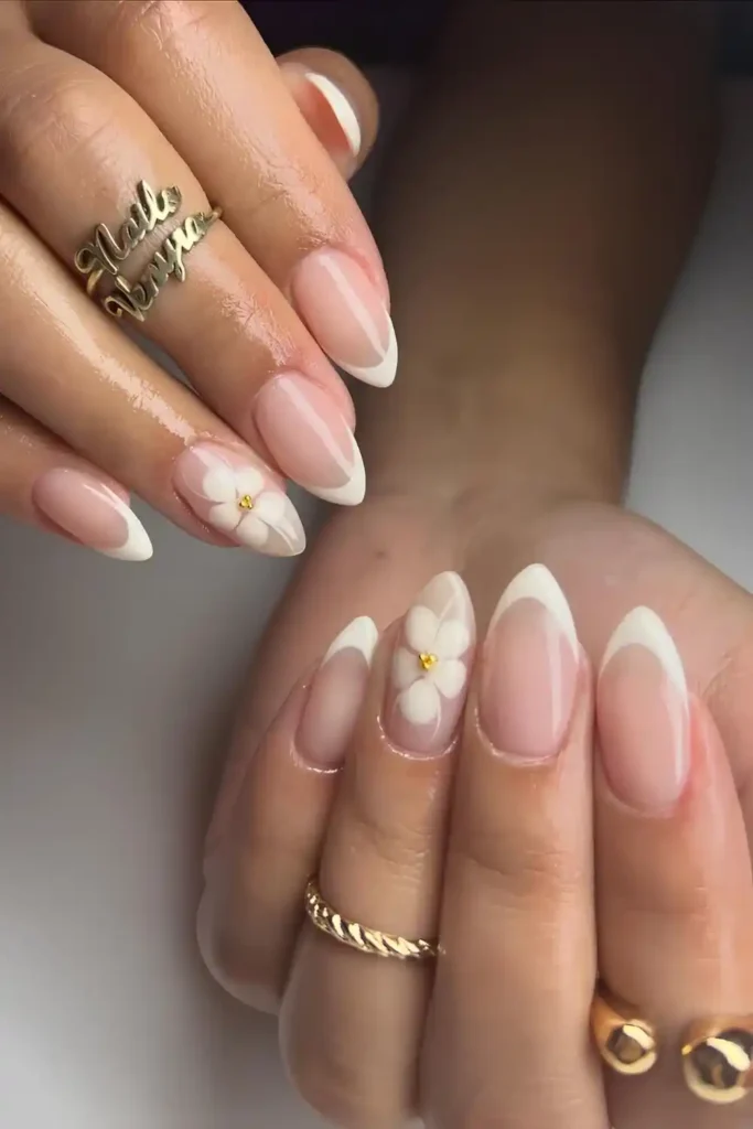 Creamy White French Almond Nails With Blooming Flower Accent That Looks Beautiful