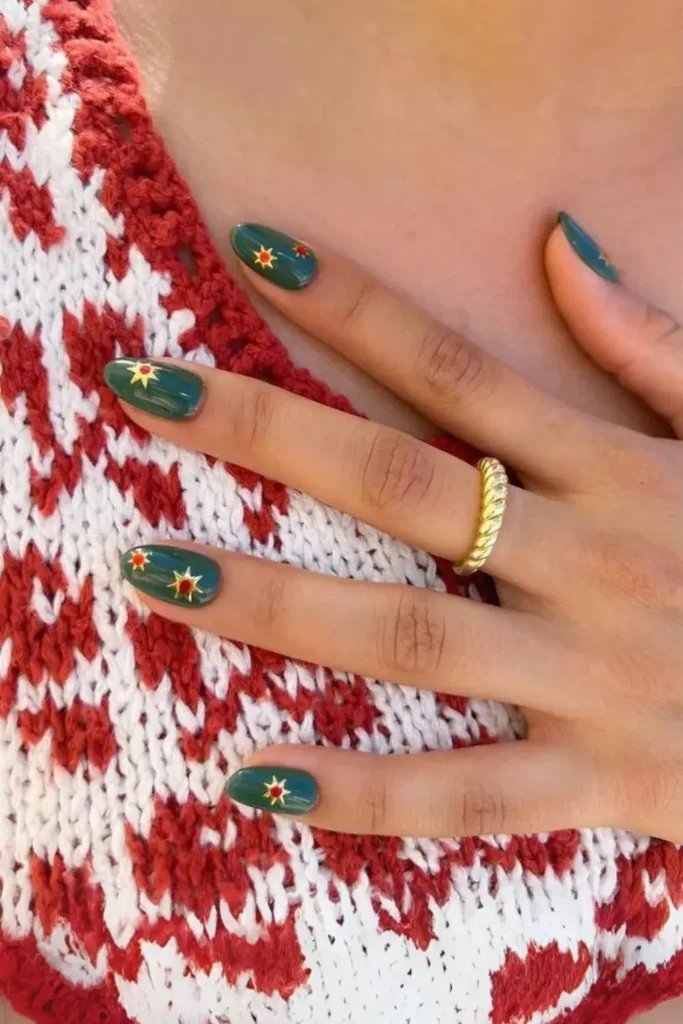 Dark Green Nails With Gold Sun Charms for a Celestial Inspired Style