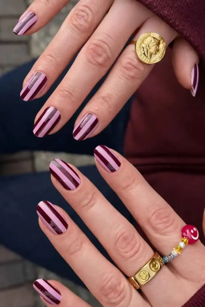 Dark Red and Pink Striped Nails That Make a Bold Statement