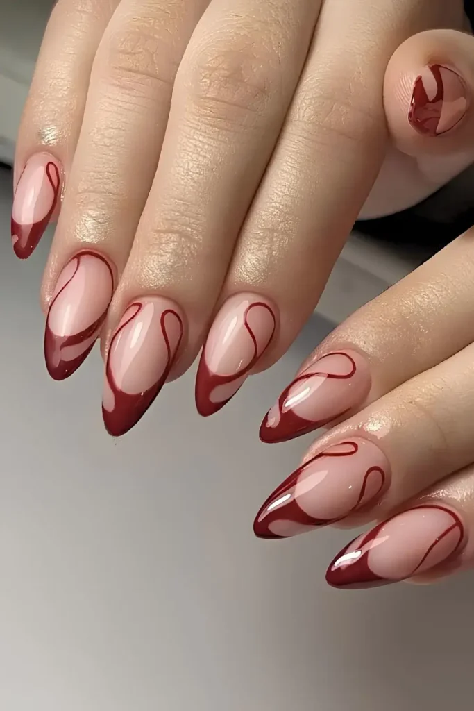 Dark Red Swirly French Tip Mani With a Chic Modern Twist