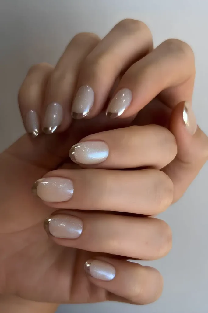 Glittery White Mani With Accent Gold Tips for a Luxe Look