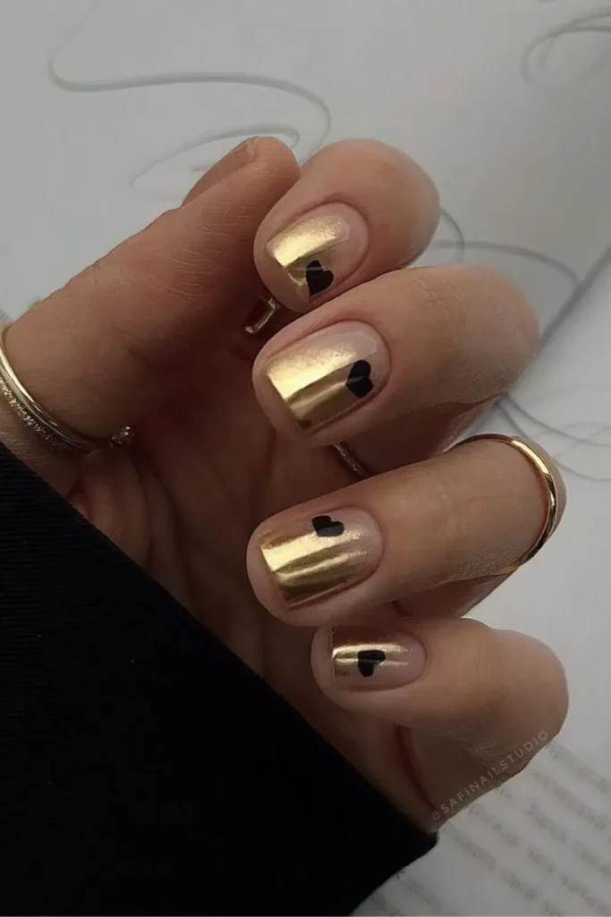 Gold Nails With Black Hearts for a Bold Romantic Touch