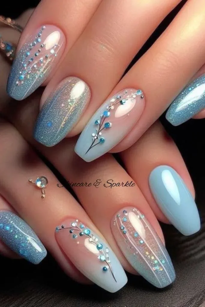 Icy Blue Ombre Nails With Delicate Floral Gem Accents That Sparkle Beautifully