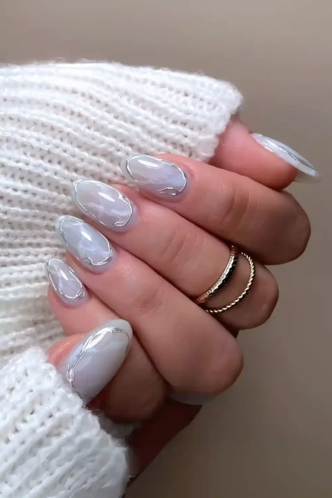 Light Blue Marble Nails With Chrome Accents for a Luxurious Look
