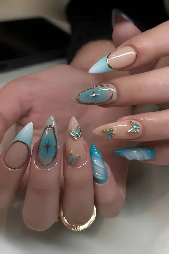 Light Blue Nails With Gold and Butterfly Accents That Feel Whimsical