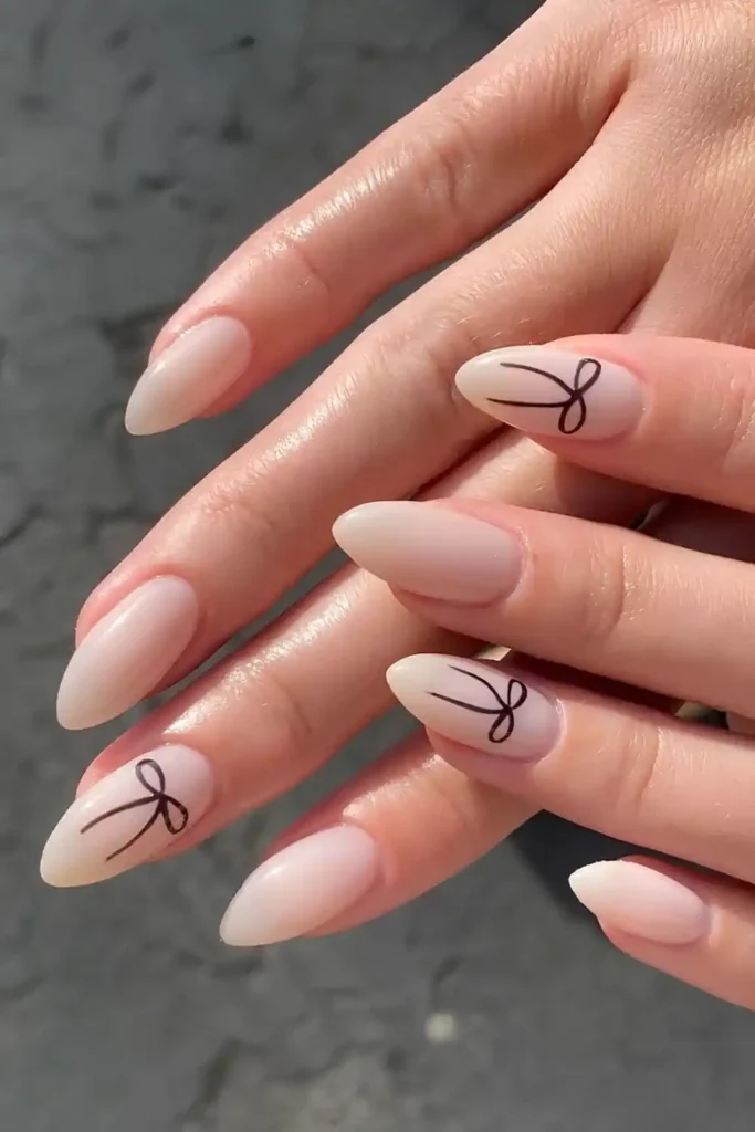 Milky Nails With Black Bow Accents for a Cute Coquette Look