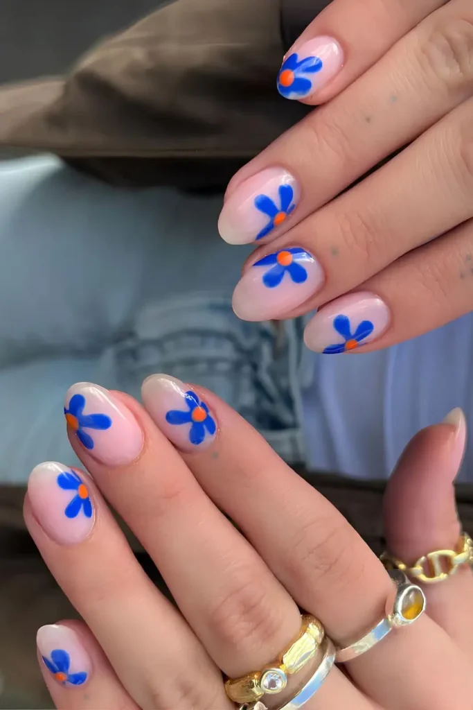 Milky Nails With Blue and Orange Floral Art for a Bright Artistic Look