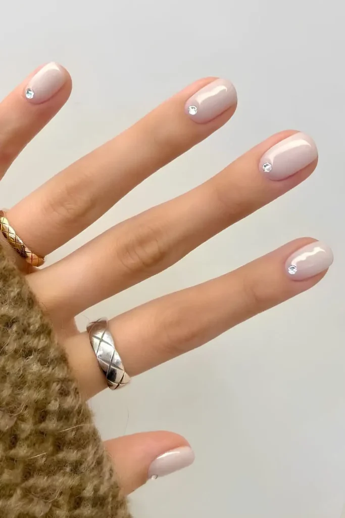 Milky White Mani With Cuticle Rhinestones That Sparkle Elegantly
