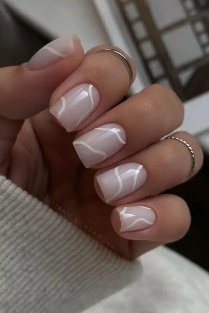 Milky White Manicure With Thin Swirls That Looks Delicate