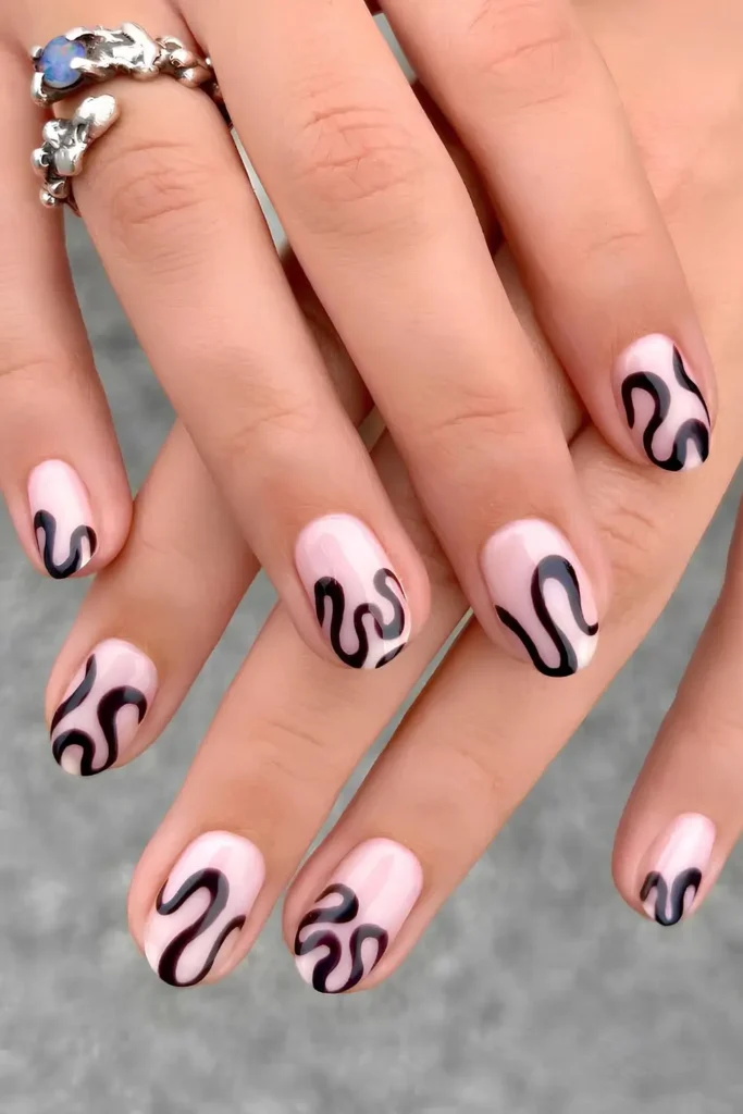 Milky White Nails With Funky Black Swirls for a Trendy Look
