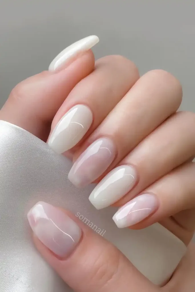 Milky White Nails With Marble Accents for an Elegant Look