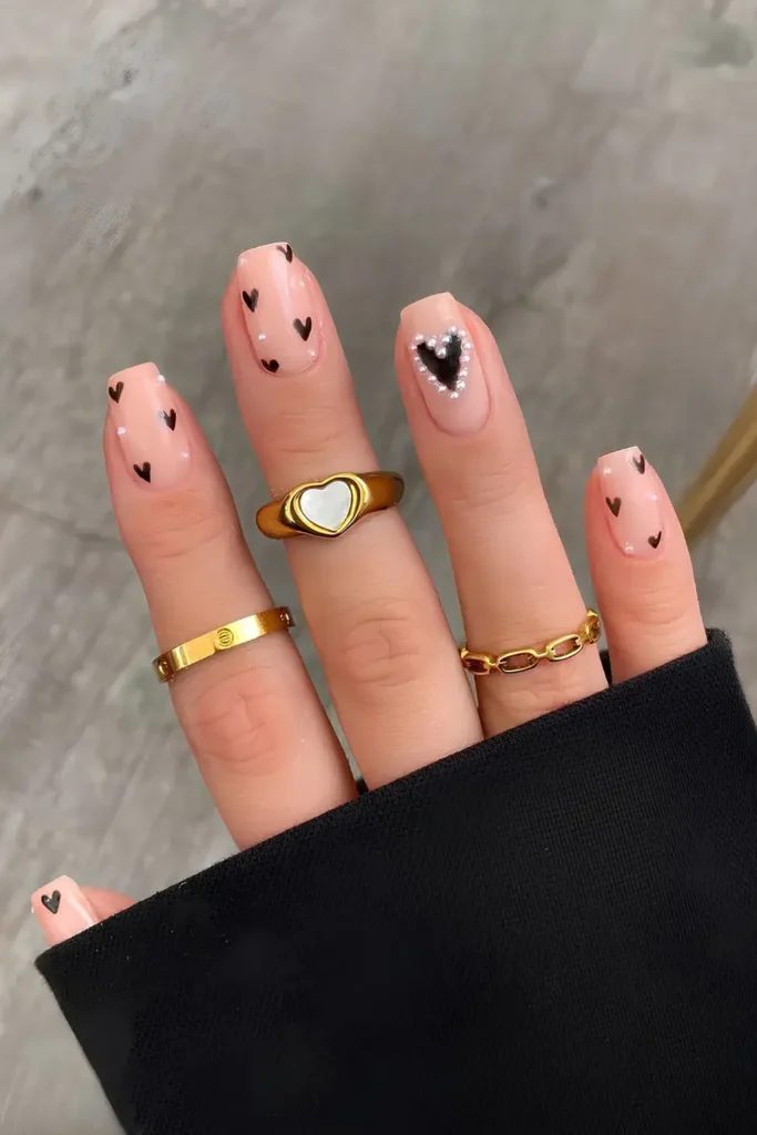 Neutral Mani With Pearls and Black Hearts for a Chic Style