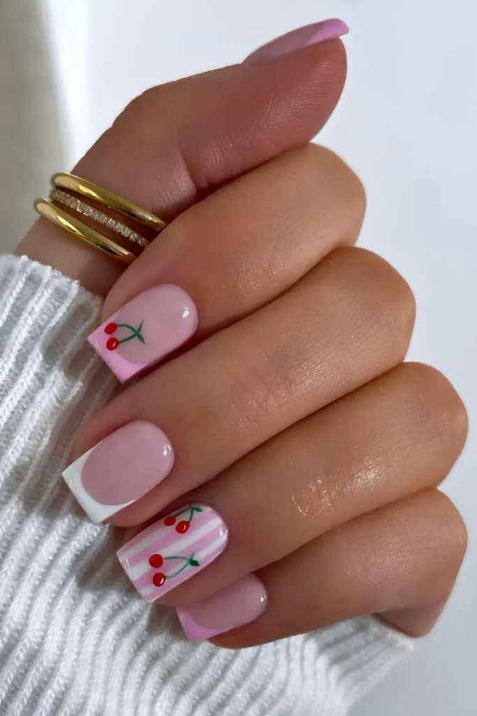 Pink and White Nails With Stripes and Cherries for a Cute Playful Look