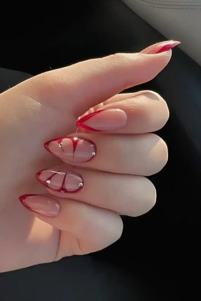 Red French Nails With Butterfly Wing Accent for a Whimsical Elegant Look