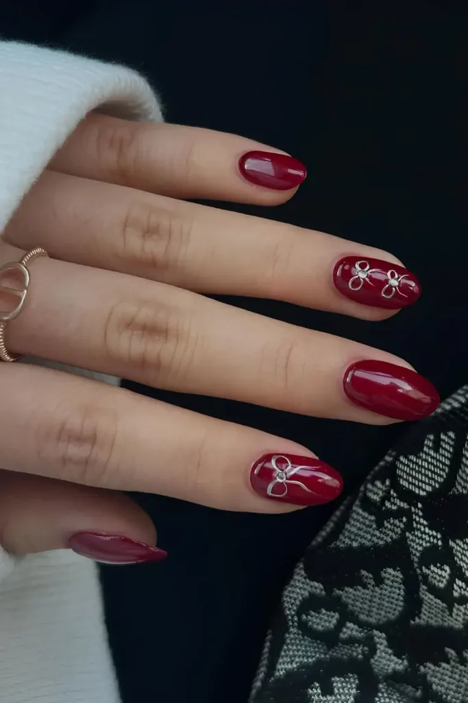 Red Mani With Silver Chrome Bows for a Glamorous Feminine Touch