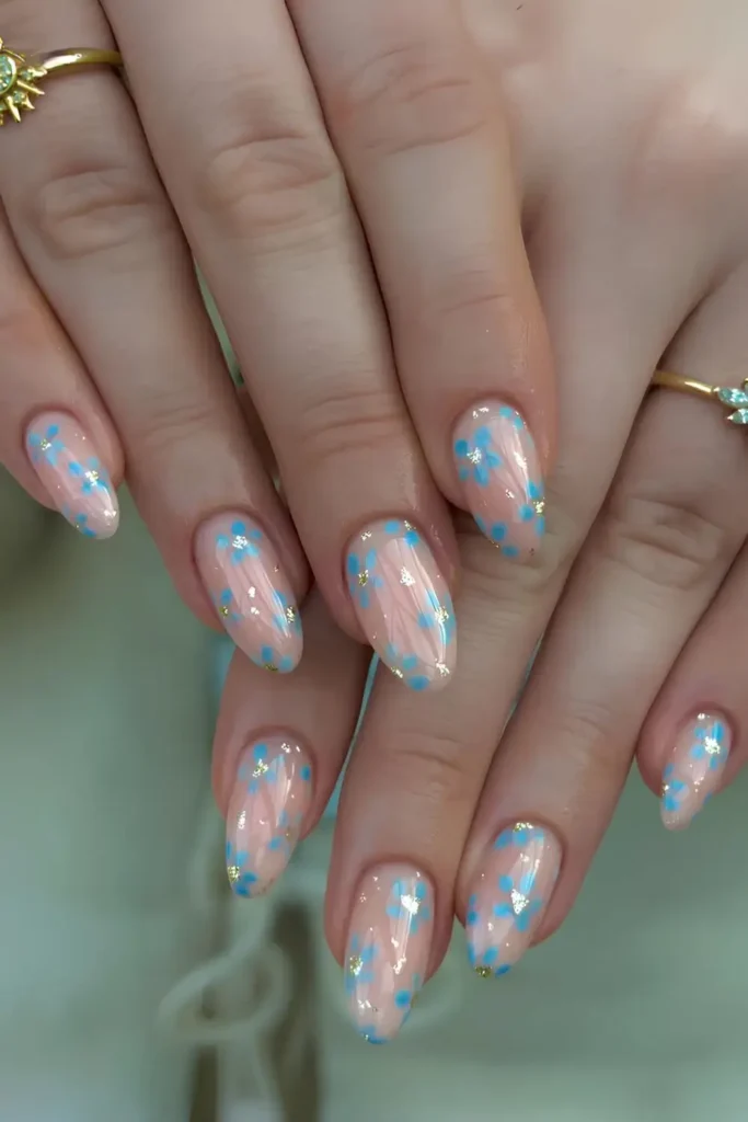 Sheer and Glossy Nails With Blue Flowers for a Delicate Romantic Look
