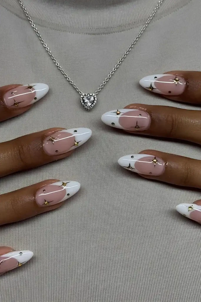 White French Nails With Gold Stars and Gems That Sparkle Beautifully