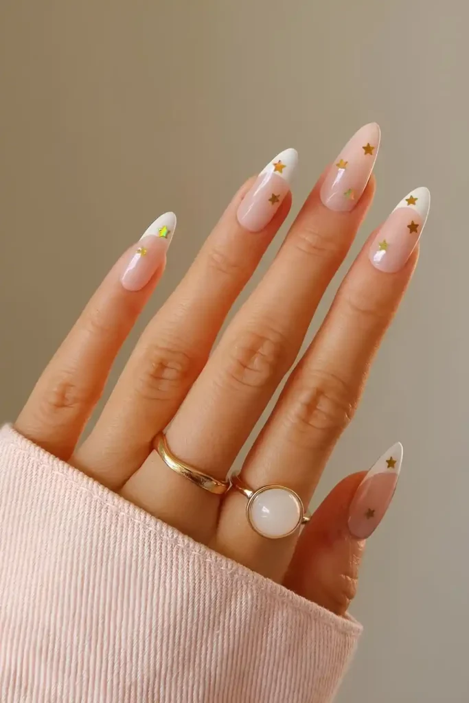 White French Nails With Gold Stars That Shine Elegantly
