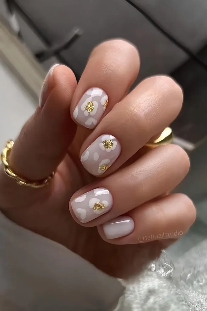 White Nails With Gold Lines and Stars for a Celestial Inspired Look